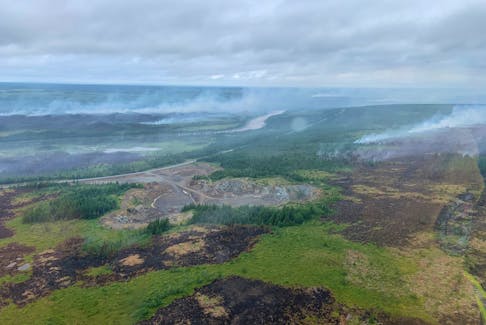 An aerial image posted on the Department of Fisheries, Foresty and Agriculture’s Twitter account on Tuesday, July 26, from Route 360, the Bay d’Espoir Highway, in central Newfoundland shows some of the areas that have been damaged by a forest fire that continues to be listed as out of control. – Department of Fisheries, Forestry and Agriculture
