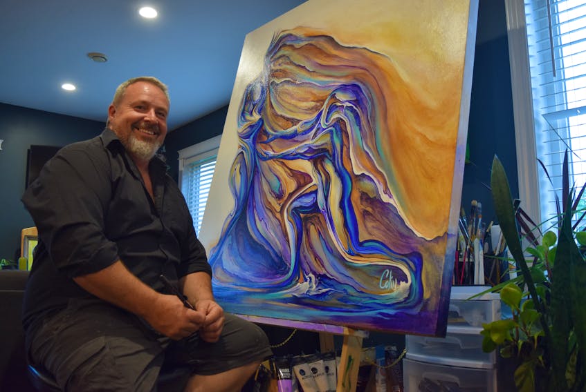 Colin Cook works in his home studio creating canvasses both large and small.
