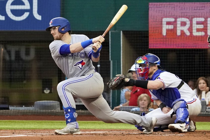 Blue Jays catcher Danny Jansen  follows thru on a single during the first inning against the Texas Rangers at Globe Life Field. Jansen went 4-for-5 with a homer and three RBIs in the Jays' 11-7 win.