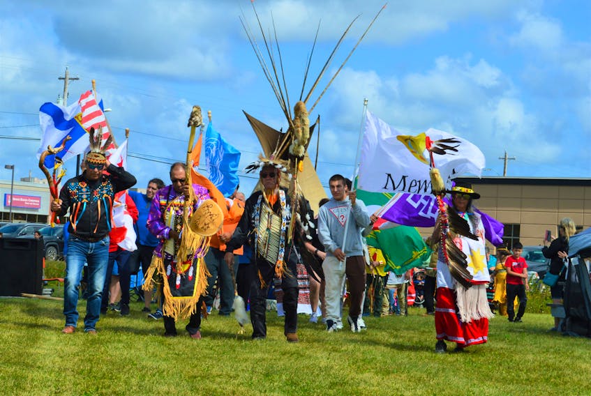 The eagle staff carriers lead the Grand Entry at the Membertou Powwow on Saturday. From left are Keith Denny, Charles Pierro, Lawerence Wells, Gram Basque and Marie Julian. NICOLE SULLIVAN / CAPE BRETON POST