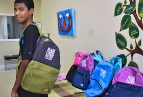 Sixteen-year-old Xavier Powell tries on the free backpack he picked up recently from an initiative by CEO and founder of Teens Now Talk magazine, Jessica Bowden. Richard MacKenzie