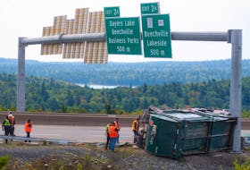 Workers and first responders attend to the scene of an accident involving a garbage truck on Highway 103 near the Bayers Lake exit on Tuesday, Sept. 13, 2022. 
Ryan Taplin - The Chronicle Herald