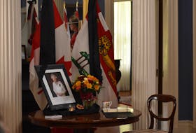 A book of condolence is next to a portrait of the  Queen at Fanningbank in Charlottetown on Sept. 12. Alison Jenkins • The Guardian
