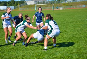 The UPEI Panthers’ Brinten Comeau, 8, tackles a St. Francis Xavier X-Women player during an Atlantic University Sport women’s rugby game at MacAdam Field on Sept. 10. UPEI players Lauren Harper, centre, and Agustina Cohen, left, hustle in to support Comeau. The Panthers won the game 32-5 and were ranked No. 9 in the U SPORTS national rankings on Sept. 13. It is the highest ranking ever for the UPEI women’s rugby team. Jason Simmonds • The Guardian