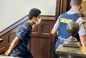 Mohammad Jamal Shned Al-Dulaimi is led into Halifax provincial court Thursday for the judge's decision at his bail hearing on six counts of sexual assault and seven of criminal harassment. He was released on $2,500 bail with one surety and placed on house arrest at his family's apartment in Bedford.