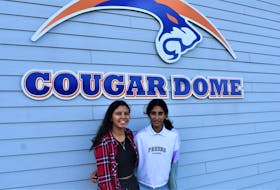 Truro teens Sofia Gonzales (left) and Meghna Anand stand beside the Cougar Dome; a home-away-from-home for the local tennis sensations who also spend a lot of time training at the outdoor Truro Tennis Club during its season.