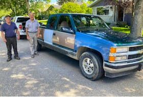 Neigbhours Clark Shanks, left, and Mark Soehner with the 1995 Chevy Silverado. Soehner drove the truck close to 360,000 kilometres before he parked it in 2017 and then sold it in 2021 to Shanks, who tended to the mechanical systems and is now repairing the body Contributed/Mark Soehner