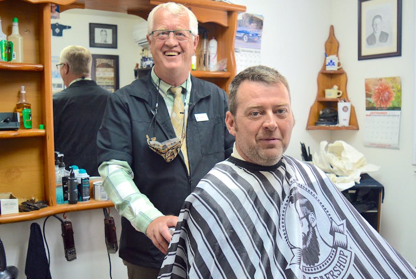 Gerry Rendell, owner of John's Barber Shop, prepares to cut the hair of longtime customer Jody Merriam. For decades, copies of Frank Magazine were strewn on a table in the lobby of the iconic Sydney River shop. The self-described collection of “news, satire, opinion, comment, and humour,” shut down Wednesday after 35 years. Chris Connors/Cape Breton Post