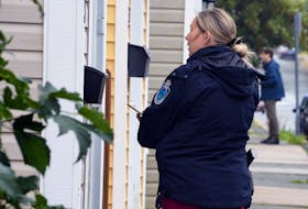 An RNC officer speaks to a resident of a home on Beaumont Street Tuesday morning following two random but violent home invasions that happened in St. John’s Monday night. -SaltWire Network/Keith Gosse