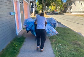 Robert Stewart walks with a cartload of recyclables on LeMarchant Street in Halifax this past September. Stewart, who gets $380 a month on social assistance, cannot find an apartment or room to rent.