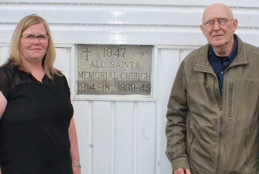 Lynn Webb, left, and Joe Hatcher stand outside All Saints Memorial Church in New Waterford, showing when construction began on the facility. IAN NATHANSON/CAPE BRETON POST