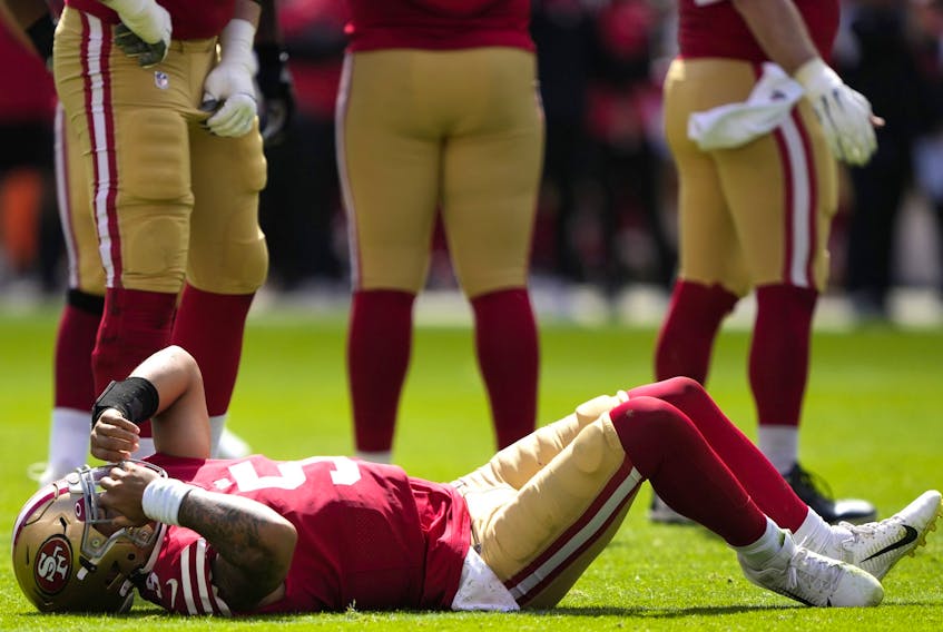  QB Trey Lance of the San Francisco 49ers lies on the field with a broken right ankle yesterday at Levi’s Stadium in Santa Clara, Calif. (Photo by Thearon W. Henderson/Getty Images)