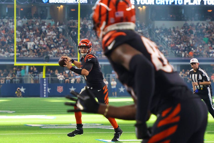 Bengals quraterback Joe Burrow passes the ball to receiver Tee Higgins for a touchdown against the Dallas Cowboys on Sunday. The Bengals, who are now 0-2, made it all the way to the Super Bowl last season.  