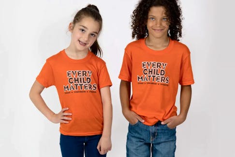 Children modelling the porcupine quills version of the "Every Child Matters" design. Contributed