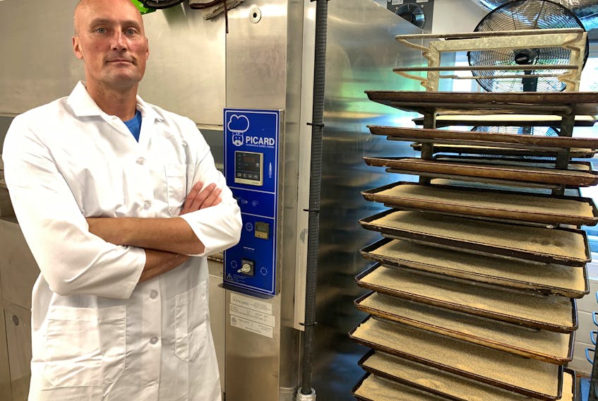 NutSmith Foods owner Rob Sedgwick stands in front of the oven that roasts various nuts and seeds before they're ground into finished products.