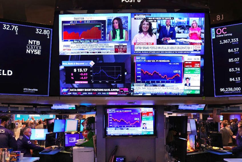 Financial News is seen on a television as traders work on the floor of the New York Stock Exchange on Aug. 29. Stocks continued their downward trend of last week in reaction to Federal Reserve Chair Jerome Powell's remarks on inflation at the central bank's annual Jackson Hole economic symposium.