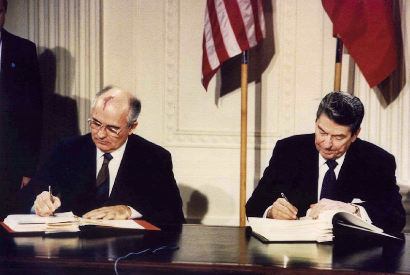 FILE PHOTO: File photo of U.S. President Ronald Reagan (R) and Soviet President Mikhail Gorbachev signing the Intermediate-Range Nuclear Forces (INF) treaty at the White House, Washington on December 8 1987. REUTERS/Dennis Paquin/File Photo  File photo of, from left, Soviet President Mikhail Gorbachev and U.S. President Ronald Reagan signing the Intermediate-Range Nuclear Forces (INF) treaty at the White House in Washington on Dec. 8, 1987. REUTERS file photo/Dennis Paquin