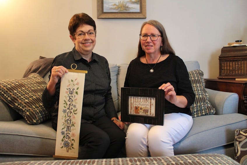 Cathy Longard (left) and Karen Hennessy (right) share some of their favorite works.