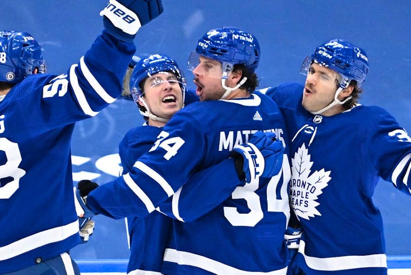 Toronto Maple Leafs forward Mitchell Marner celebrates a goal against New Jersey Devils with forwards Auston Matthews and Michael Bunting and defenseman Timothy Liljegren in the third period at Scotiabank Arena.