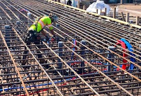 A worker fastens steel cables to ready them for a concrete pour at Southwest Properties' Cunard project on the Halifax waterfront. The building is scheduled to be completed in 2024.