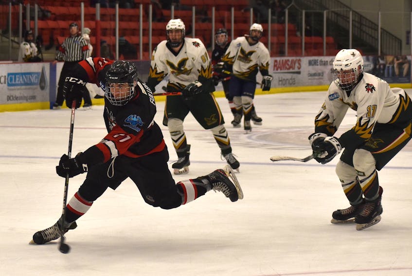 Nathaniel Fuller of the Membertou Jr. Miners, left, fires a shot on goal as he's chased by Ethan Stanwick of the Eskasoni Eagles during Nova Scotia Junior Hockey League regular season action at the Membertou Sport and Wellness Centre last season. Fuller will return to the Jr. Miners lineup this season and will be expected to produce offence for the club. JEREMY FRASER/CAPE BRETON POST