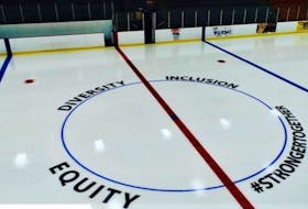 In bold, block lettering, the words ‘equity,’ ‘diversity,’ and ‘inclusion,’ as well as the hashtag ‘#StrongTogether,’ are painted around the centre ice faceoff circle at the Colchester Legion Stadium. Contributed