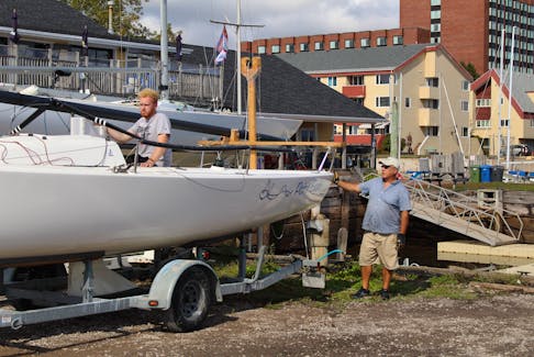 Stephen Taweel, standing, and his crew work on hauling their boat out of the water at the Charlottetown Yacht Club on Sept. 21. Rafe Wright • The Guardian