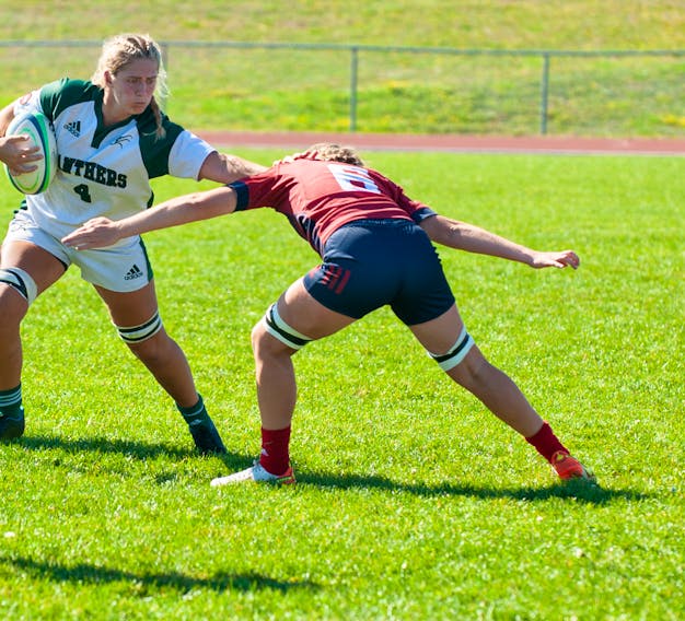 Carla Stewart, 4, of the UPEI Panthers looks to avoid a tackle attempt by the Acadia Axewomen’s Danielle Wise, 8, during an Atlantic University Sport women’s rugby game at MacAdam Field in Charlottetown on Sept. 17. The Panthers won the game 38-5. UPEI was ranked seventh in this week’s U SPORTS women’s rugby rankings.  Janessa Hogan Photo • Courtesy of UPEI Athletics