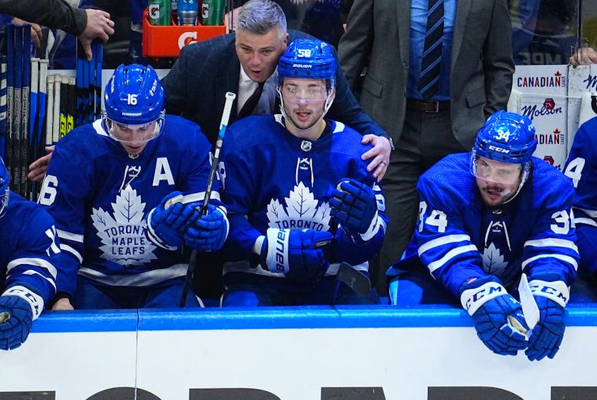 May 10, 2022; Toronto, Ontario, CAN; Toronto Maple Leafs head coach Sheldon Keefe congratulates Mitchell Marner (16) and forward Michael Bunting (58) on assisting on the goal by forward Auston Matthews (34) against the Tampa Bay Lightning during the third period of game five of the first round of the 2022 Stanley Cup Playoffs at Scotiabank Arena.  