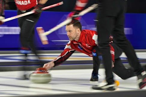 Canada Skip Brad Gushue delivers a stone against Sweden during a gold medal game at the World Men's Curling Championships, Sunday, April 10, 2022, in Las Vegas.