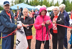 Cancer survivors and flag bearers Dana and Judy Flemming join long-time participant Pearl Cameron, at 93-years-of-age, and Terry Fox Run committee member Judy Matheson, in cutting the ribbon to start the 2022 Brookfield Terry Fox Run.
