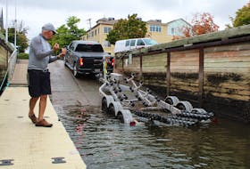 Shane Toombs guides a truck into the Peakes Quay to haul out his boat in Charlottetown on Sept. 22. Rafe Wright • The Guardian