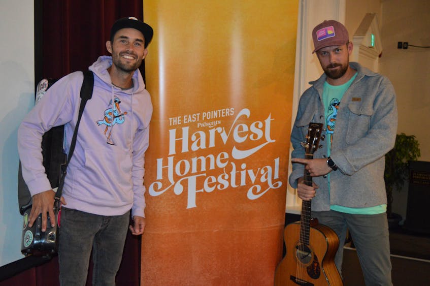 Tim Chaisson, left, and Jake Charron stand in front of a Harvest Home Festival poster as part of an interview with SaltWire Network on Sept. 16. The event has since been cancelled due to hurricane Fiona’s expected impact in P.E.I. this weekend. Dave Stewart • The Guardian