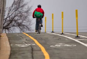 FOR NEWS STANDALONE:
A cyclist rides on the city's first protected bike lane, recent;ty opened on Rainnie Drive in Halifax, Tuesday November 24, 2015. , The bike lane is separated from vehicle traffic by a painted buffer on the road, as well as plastic posts and on-street parking next to the posts. The buffer and posts are in what's often referred to as the 'door zone' to provide separation from the doors of parked vehicles and the people travelling on bikes....

TIM KROCHAK/Staff  A cyclist rides on the city’s first protected bike lane in November 2015 on Rainnie Drive in Halifax. The bike lane is separated from vehicle traffic by a painted buffer on the road, as well as plastic posts and on-street parking next to the posts. The buffer and posts are in what's often referred to as the 'door zone' to provide separation from the doors of parked vehicles and the people travelling on bikes. But some advocates believe much more should be done to make Halifax friendlier for bikers, with many still being injured by vehicles despite the bike lanes. TIM KROCHAK/Herald