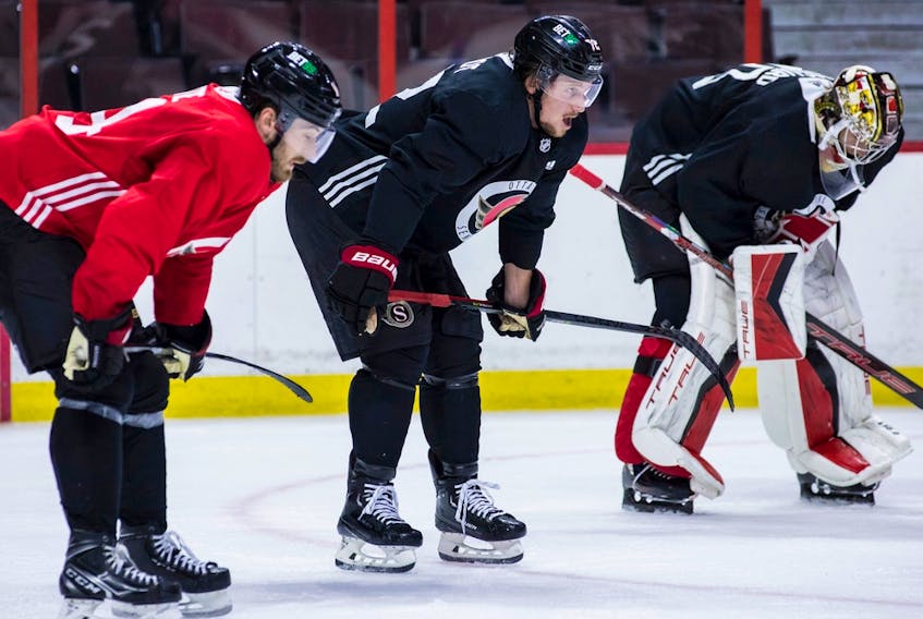  Teammates (left to right) Tyler Motte, Thomas Chabot and Mads Sogaard catch their breath during an on ice session during training camp at the Canadian Tire Centre on Sept. 22, 2022.