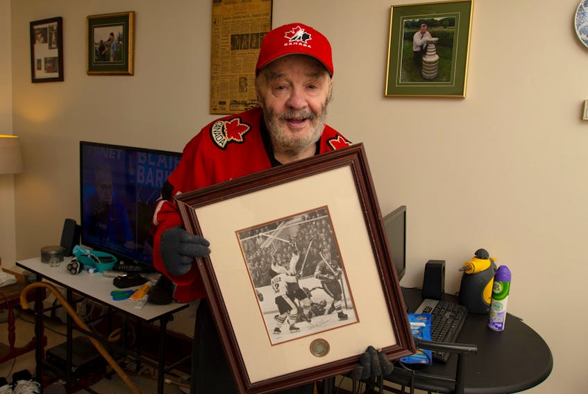 Alex J. Walling holds up a framed photo of Paul Henderson's 1972 Summit Series-winning goal at his Dartmouth apartment on Monday, Sept. 19, 2022.
Ryan Taplin - The Chronicle Herald