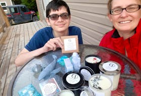 Trina and Scott Reid with some of their Under the Stump candles and soaps. - Contributed