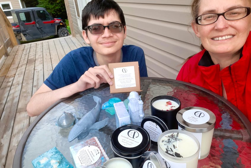 Trina and Scott Reid with some of their Under the Stump candles and soaps. - Contributed