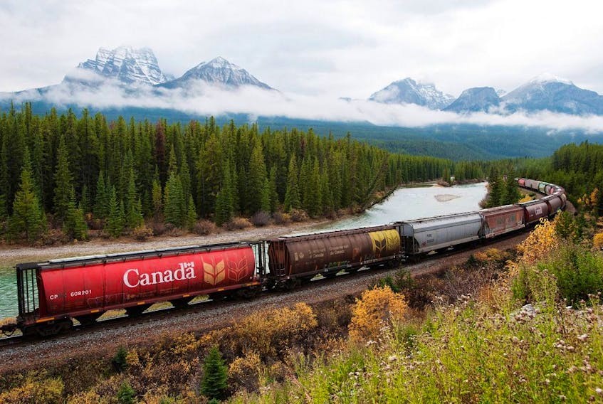  Rail cars loaded with Canadian wheat travel through the Rocky Mountains on the Canadian Pacific Railway line near Banff, Alta.