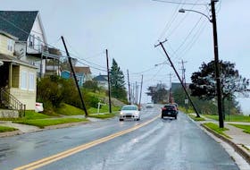A utility pole leans as the wind from post-tropical cyclone Fiona pushes it outward dangerous close to a home near Archibald's Wharf in North Sydney on Saturday. NICOLE SULLIVAN/CAPE BRETON POST