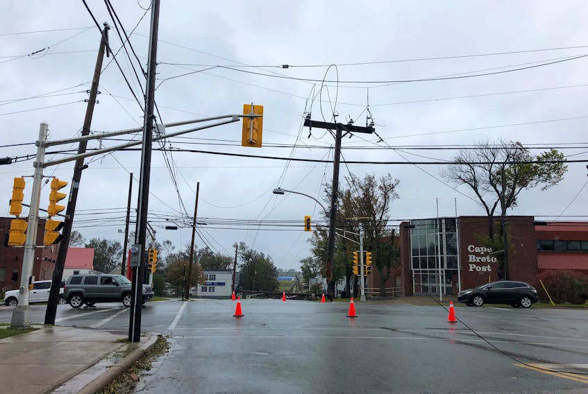 A snapped power pole in the wake of post-tropical storm Fiona leaves a live wire dangling along Dorchester Street near George Street in Sydney on Saturday. IAN NATHANSON/CAPE BRETON POST
