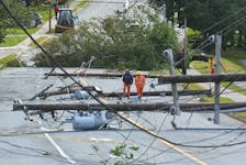 Nova Scotia Power employees walk down a stretch of Woodlawn Road in Dartmouth that was heavily damaged during hurricane Fiona on Saturday, Sept. 24, 2022. Ryan Taplin - The Chronicle Herald