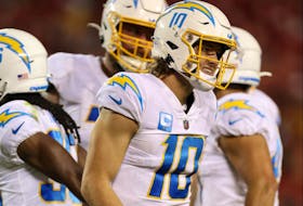 Justin Herbert #10 of the Los Angeles Chargers reacts in pain after a play during the fourth quarter against the Kansas City Chiefs at Arrowhead Stadium on September 15, 2022 in Kansas City, Missouri. (Photo by Jamie Squire/Getty Images)