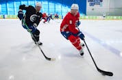  Vancouver Canucks’ Brock Boeser, right, tries to keep the puck away from Oliver Ekman-Larsson training camp in Whistler on Thursday, Sept. 22, 2022.