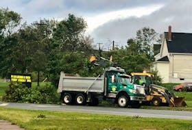 Cape Breton Regional Municipality crews clean up fallen trees in Sydney at Ashby Corner Saturday evening. Although the storm ravaged the CBRM for almost the full day many roadways were cleared before dark. NICOLE SULLIVAN / CAPE BRETON POST