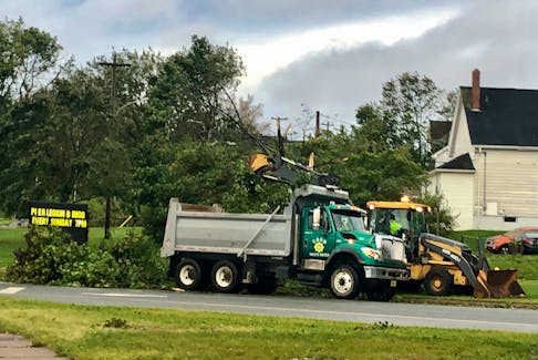 Cape Breton Regional Municipality crews clean up fallen trees in Sydney at Ashby Corner Saturday evening. Although the storm ravaged the CBRM for almost the full day many roadways were cleared before dark. NICOLE SULLIVAN / CAPE BRETON POST