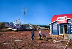 Kathy Brown and Barb Doiron assess the damage in Stanley Bridge on Sept. 25 following post-tropical storm Fiona. Doiron, who owns Bay View Antiques, said the storm was the worst she's ever seen. Nathan Rochford • Special to The Guardian
