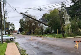 A snapped utility pole on Central Street in Summerside hangs from the overhead wires on Sept. 24 after post-tropical storm Fiona. Jason Simmonds • The Guardian