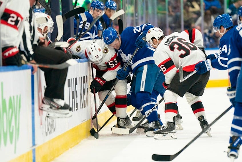 Maple Leafs winger Joey Anderson (28) battles along the boards with Ottawa Senators forward Matthew Wedman during an exhibition doubleheader on Saturday in Toronto.