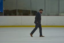 UNB Reds head coach Gardiner MacDougall walks across the ice during an intermission of an AUS men’s hockey game against the UPEI Panthers at MacLauchlan Arena in Charlottetown during the 2021-22 season. MacDougall, from Bedeque, P.E.I., has been named the head coach of the Canadian men’s hockey team for the 2023 FISU Winter World University Games in Lake Placid, N.Y. Jason Simmonds • The Guardian